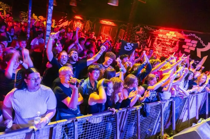 Full band on stage under club lights