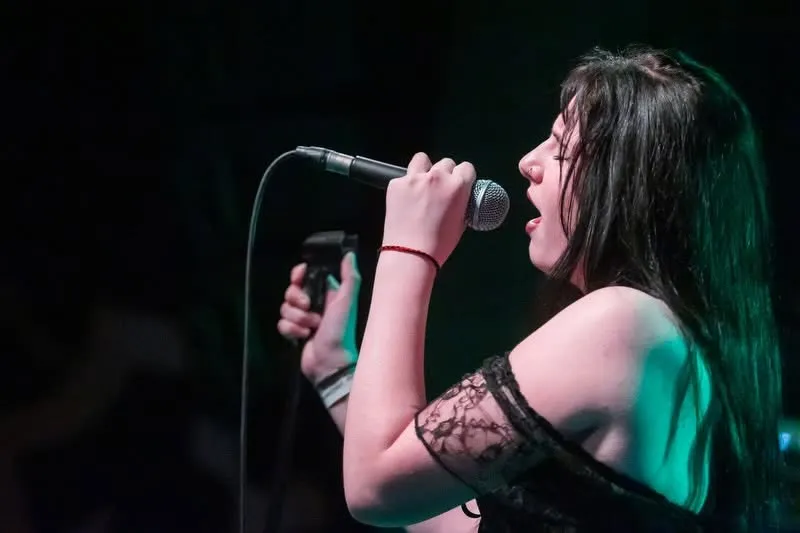 Vocalist close-up under a spotlight